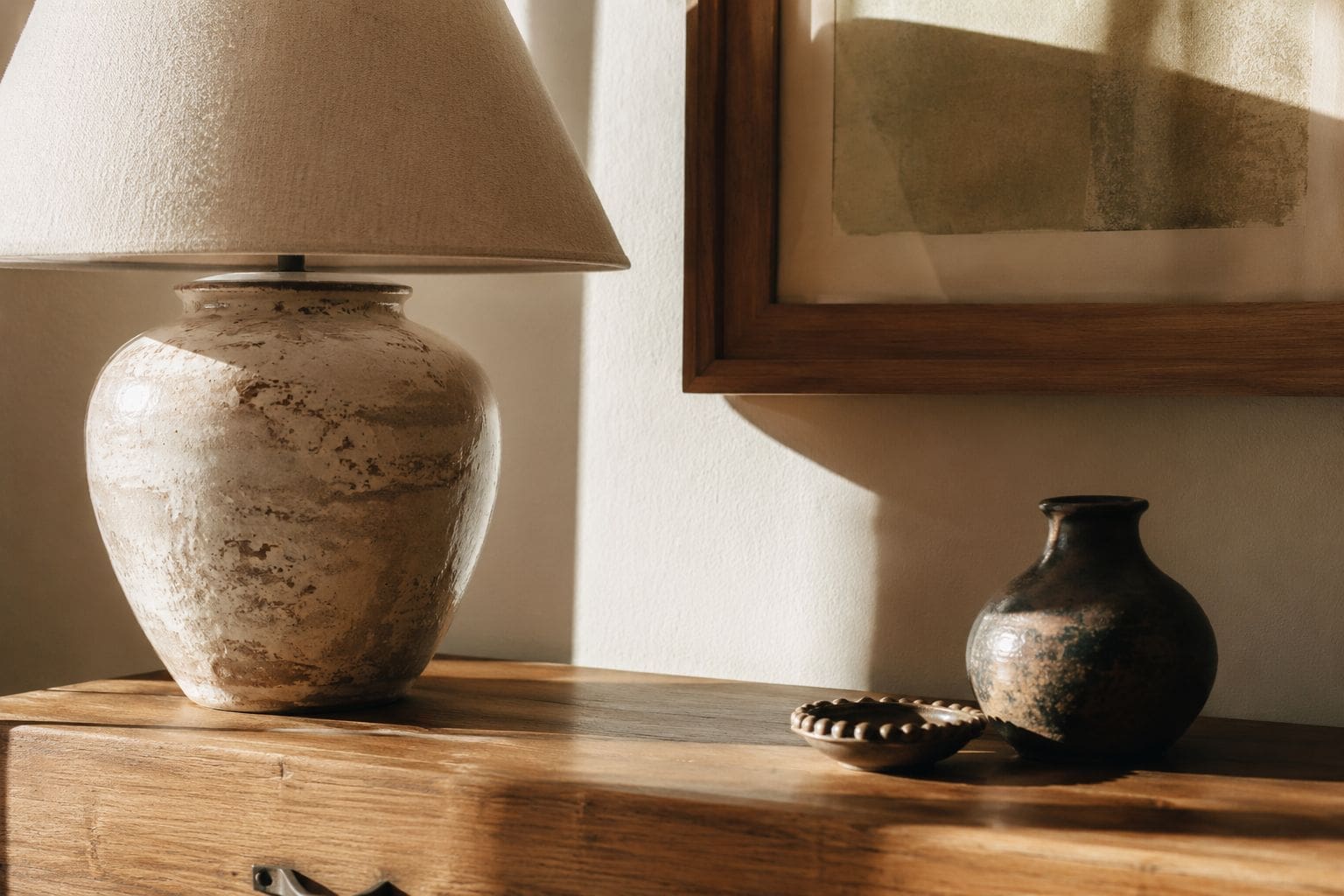 Styled console table with anchor lamp and small accents illustrating the anchors before accents principle